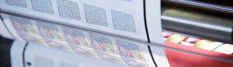 Display of labels with reverse-side printing still in the printing press.